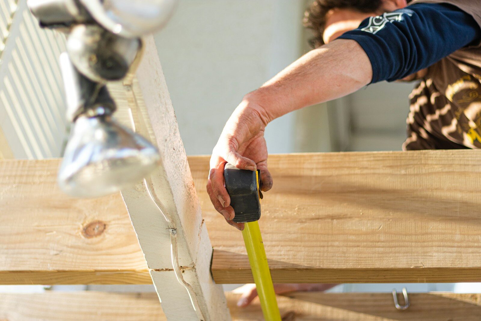 person holding black and green power tool