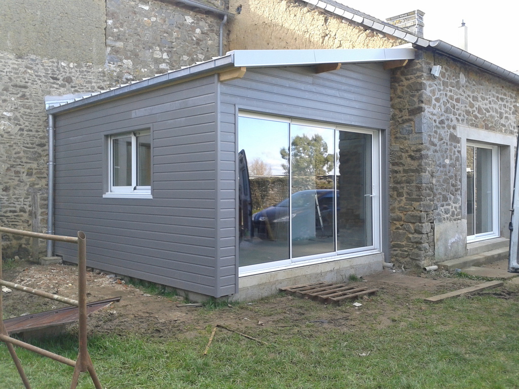 the shadow of a person standing on a wooden deck
